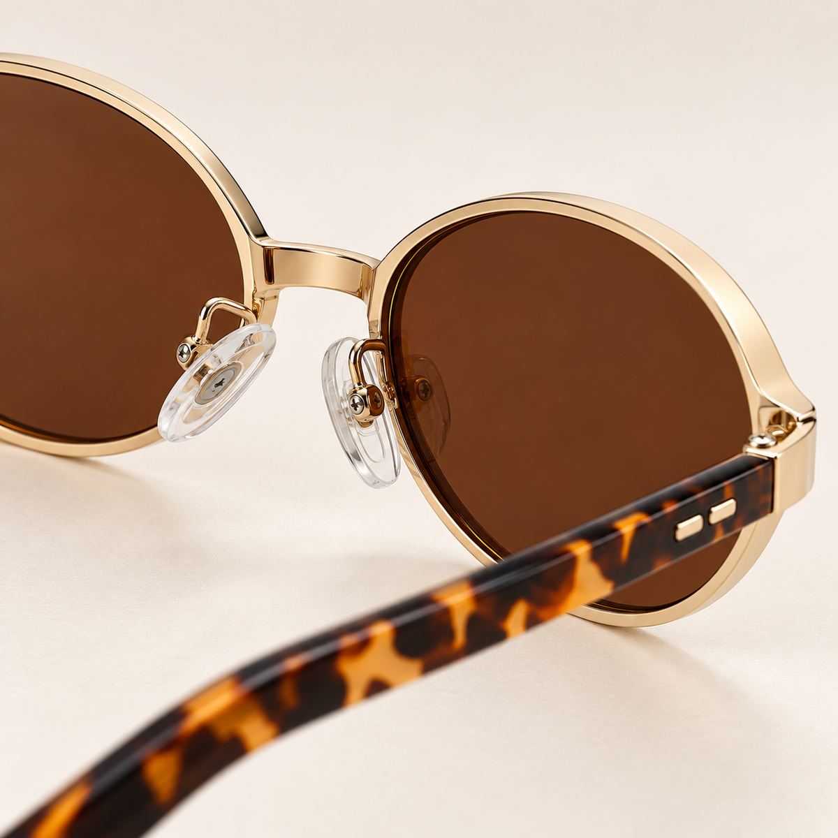 Isella Oval Metal Sunglasses in Gold Tortoise - bridge and clear adjustable nose pads detail